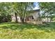 Backyard view of house, multi-level deck, and lawn with surrounding trees at 6374 Timberbluff Cir, Avon, IN 46123