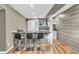 Basement bar area with stone accents, countertop seating, sink, and cabinet storage at 6374 Timberbluff Cir, Avon, IN 46123