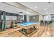 Finished basement featuring a pool table, projector screen, bar area, and hardwood floors at 6374 Timberbluff Cir, Avon, IN 46123
