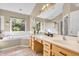 Bathroom includes dual sink vanity, soaking tub, and large window with wooded view at 6374 Timberbluff Cir, Avon, IN 46123