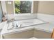 Close up of the bathtub in the bathroom with tile surround and window at 6374 Timberbluff Cir, Avon, IN 46123