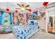 Fun bedroom with dinosaur theme, light pink walls, wood floor, and a ceiling fan with light at 6374 Timberbluff Cir, Avon, IN 46123