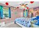 A bedroom with dragon decor, fun fabrics and a ceiling fan at 6374 Timberbluff Cir, Avon, IN 46123