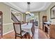 Formal dining room features hardwood floors, a decorative light fixture, and views of the front entry at 6374 Timberbluff Cir, Avon, IN 46123