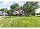 A well-maintained lawn and mature trees frame this beautiful brick home at 6374 Timberbluff Cir, Avon, IN 46123