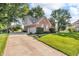 Beautiful red brick two-story home with a long driveway and well-manicured lawn at 6374 Timberbluff Cir, Avon, IN 46123