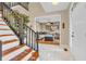 Bright foyer with staircase and view into the living room and front door at 6374 Timberbluff Cir, Avon, IN 46123