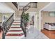 Grand two-story foyer with staircase, marble tile floor, and view into living spaces at 6374 Timberbluff Cir, Avon, IN 46123