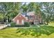 Charming brick home with lush landscaping, blue shutters and a well-manicured lawn at 6374 Timberbluff Cir, Avon, IN 46123
