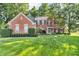Charming brick home with manicured lawn, garden, and classic architectural details at 6374 Timberbluff Cir, Avon, IN 46123