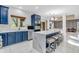 Open kitchen with a waterfall island, barstool seating, modern appliances, and custom blue cabinets at 6374 Timberbluff Cir, Avon, IN 46123