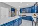 Well-equipped kitchen with stainless steel appliances, blue cabinetry, and ample counter space for cooking at 6374 Timberbluff Cir, Avon, IN 46123