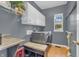 Functional laundry room with modern washer and dryer, storage cabinets, and a convenient folding station at 6374 Timberbluff Cir, Avon, IN 46123