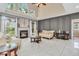 Bright living room featuring a fireplace, high ceilings, large windows, and elegant neutral-toned furniture at 6374 Timberbluff Cir, Avon, IN 46123