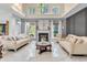 Bright living room with a fireplace, large windows, and stylish decor at 6374 Timberbluff Cir, Avon, IN 46123
