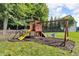 Backyard wooden playground structure with swings, slide, and climbing area at 6374 Timberbluff Cir, Avon, IN 46123