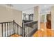 Elegant staircase with dark wood railings and hardwood floors, leading to a brightly lit upper level at 6374 Timberbluff Cir, Avon, IN 46123