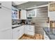Wet bar area with white cabinetry, countertop, sink, and wine storage; beer print on wall at 6374 Timberbluff Cir, Avon, IN 46123