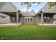 Expansive backyard with a lush green lawn and covered patios on each side at 6553 Stone Pointe Way, Indianapolis, IN 46237