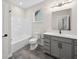 Clean bathroom with modern vanity, tub, and gray tiled floor showcases simple elegance at 6553 Stone Pointe Way, Indianapolis, IN 46237