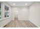 Bright bedroom features wood-look floors, neutral paint, large window, and a door to the walk-in closet at 6553 Stone Pointe Way, Indianapolis, IN 46237
