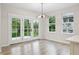 Bright dining area with double doors leading to the backyard and large windows at 6553 Stone Pointe Way, Indianapolis, IN 46237