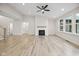 Bright living room featuring a fireplace, large windows, and wood-look flooring at 6553 Stone Pointe Way, Indianapolis, IN 46237