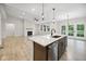 Open concept living room and kitchen area featuring modern finishes, lots of light, and wood-look flooring at 6553 Stone Pointe Way, Indianapolis, IN 46237