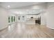 Open-concept living room showcases hardwood floors and seamless flow to the kitchen area at 6553 Stone Pointe Way, Indianapolis, IN 46237