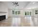 Open living area featuring a fireplace, large windows, and wood-look flooring at 6553 Stone Pointe Way, Indianapolis, IN 46237