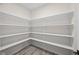 Walk-in pantry featuring ample shelving for storage and wood-look flooring at 6553 Stone Pointe Way, Indianapolis, IN 46237