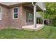 A covered patio features a brick wall and gray trim, perfect for relaxing at 6553 Stone Pointe Way, Indianapolis, IN 46237