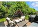 Backyard deck with outdoor furniture and lush landscaping at 6570 Freemont Ln, Carmel, IN 46033