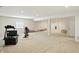 Finished basement featuring neutral carpet, exercise equipment, and an open floor plan at 6570 Freemont Ln, Carmel, IN 46033
