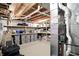 Unfinished basement with exposed pipes, shelving, and storage containers at 6570 Freemont Ln, Carmel, IN 46033