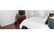 Bright bedroom featuring a large bed, dark wood floors, and dresser at 6570 Freemont Ln, Carmel, IN 46033