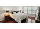 Bright bedroom featuring a large bed, dark wood floors, and plenty of natural light from the window at 6570 Freemont Ln, Carmel, IN 46033