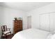Bright bedroom with hardwood floors, closet with sliding doors, and a dresser at 6570 Freemont Ln, Carmel, IN 46033