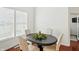 Dining room features a dark wood table with seating for four and bright natural light at 6570 Freemont Ln, Carmel, IN 46033