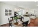 Elegant dining room with hardwood floors, stylish chandelier, and open view to the modern kitchen at 6570 Freemont Ln, Carmel, IN 46033