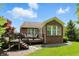 A brick home featuring a backyard deck with seating and an awning, with mature landscaping at 6570 Freemont Ln, Carmel, IN 46033