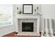 Close-up of a modern fireplace with tile surround and decorative mantle at 6570 Freemont Ln, Carmel, IN 46033