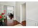 Elegant foyer with hardwood floors and white wainscoting, transitioning seamlessly into the living space at 6570 Freemont Ln, Carmel, IN 46033