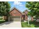 Beautiful brick home with a well-maintained lawn, a two-car garage, and lovely landscaping at 6570 Freemont Ln, Carmel, IN 46033