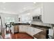 Well-lit kitchen featuring stainless steel appliances, white cabinetry, and an open view to the dining area at 6570 Freemont Ln, Carmel, IN 46033