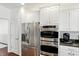 Kitchen with stainless steel appliances, white cabinets, double oven and eat in kitchen, coffee maker at 6570 Freemont Ln, Carmel, IN 46033