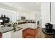 Modern kitchen with white cabinets, granite countertops, stainless steel appliances, and hardwood floors at 6570 Freemont Ln, Carmel, IN 46033