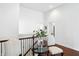 Light-filled landing featuring a table and chairs and railing at 6570 Freemont Ln, Carmel, IN 46033