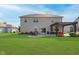 Expansive backyard featuring a pergola, fire pit, patio, and lush green lawn, great for outdoor living at 6664 Kara Ln, Brownsburg, IN 46112