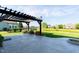 Outdoor patio with pergola, stone fire pit, and views of the pond and backyard at 6664 Kara Ln, Brownsburg, IN 46112
